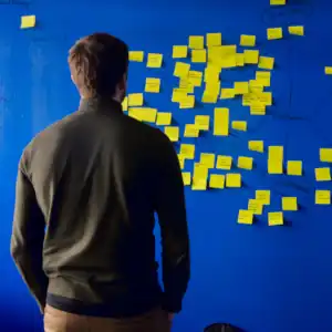 A man stares at a wall of stickies